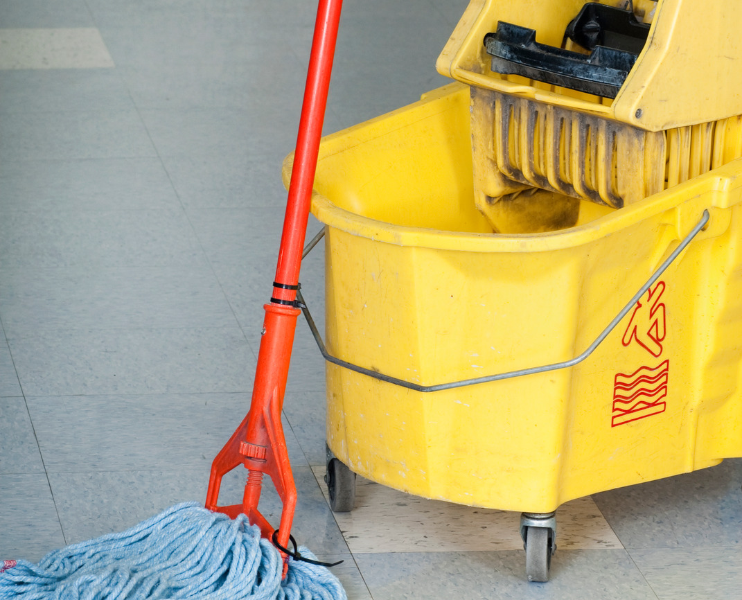 A dirty mop bucket cart