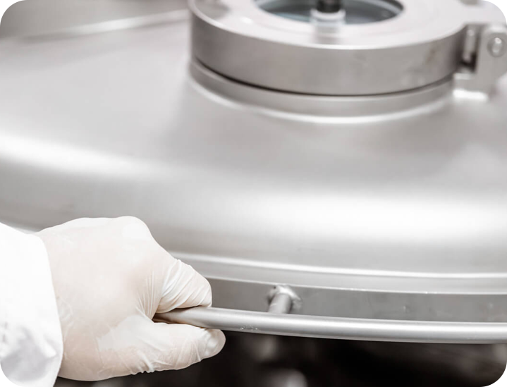 the hand of a laboratory technician holding a machine