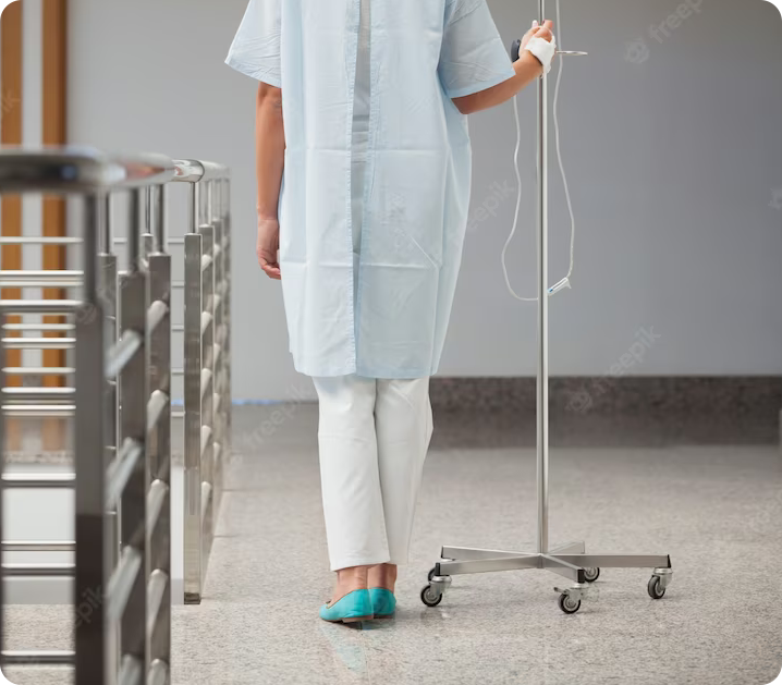 patient walking while holding an IV pole