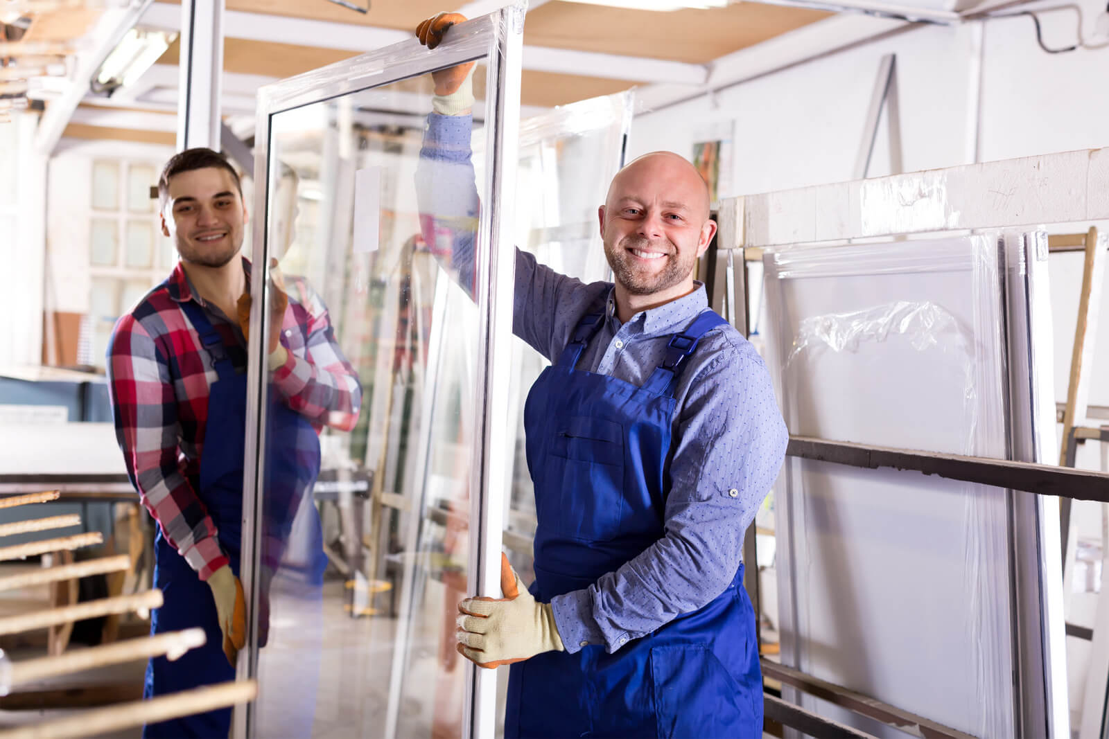 two window replacement professionals holding a window