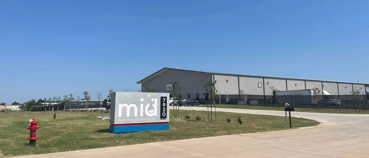 Industrial chemical warehouse with palletized drums and totes — Mid-America Chemical