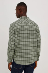 The Rails Lennox Shirt in Birch Forest is a best-selling, relaxed-fit men's plaid button-down. Crafted from a luxurious 55% cotton and 45% rayon blend, it is double-brushed on both sides for unmatched softness, featuring a classic spread collar, single chest pocket, and a curved shirttail hem.