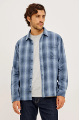 Shop the Rails Owens Shirt in Blue Mist Shadow, a lightweight 100% cotton gauze button-up. This relaxed-fit mens shirt features a soft herringbone texture, classic spread collar, chest patch pocket, and barrel cuffs, offering breathable, go-anywhere everyday style.