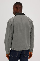 The Rails Morro Jacket in Graphite is a men's heavy cotton canvas duck utility jacket with a garment-dyed finish. It features a classic corduroy collar, a zip chest pocket, side welt pockets, and workwear shank button tabs at the back hem.