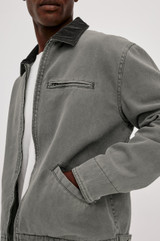The Rails Morro Jacket in Graphite is a men's heavy cotton canvas duck utility jacket with a garment-dyed finish. It features a classic corduroy collar, a zip chest pocket, side welt pockets, and workwear shank button tabs at the back hem.