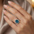 Oval London Blue Topaz and Diamond Halo Statement Ring On Hand