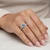 Blue Diamond Infinity Halo Engagement Ring On Hand