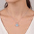Triangular-Cut Blue Aquamarine And Diamond Halo Pendant On Model