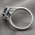 Blue and White Diamond Halo Engagement and Wedding Ring Set Side