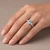 Oval Blue Aquamarine and Diamond Three-Stone Engagement Ring On Hand