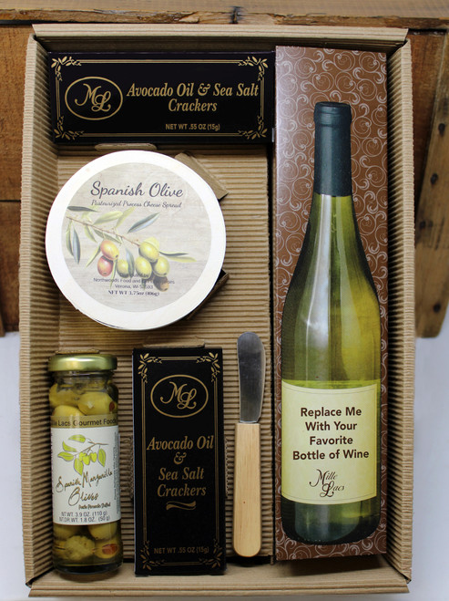 ML7012 From The Cellar Spanish Olive Spread Gift 6/case, contains 1.1oz of Avacado Oil and Sea Salt Crackers, 3.75oz Spanish Olive Cheese Spread in wooden hoop, 2oz of Imported Spanish Manzanilla Olives, wooden handled cheese spreader knife and a location for a favorite bottle of wine, has a clear lid to complete the gift.