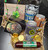 Celebrate St. Patrick’s Day with this charming Wisconsin-themed gift basket, perfect for beer lovers and snack fans alike. This basket features a great selection of local flavors and festive treats, all beautifully arranged in a sturdy basket shaped like the state of Wisconsin.

Includes:

Lakeside Brewery Near Beer Cans: Pale, Amber, and Dark

6 oz spicy beer cheese from The Leprechaun

5 oz beef summer sausage

Potter’s crackers

2 oz dipping pretzels from Eastshore

5 chocolate gold coins

A fun and festive basket that highlights Wisconsin favorites — ideal for gifting, raffles, or St. Patrick’s Day celebrations.