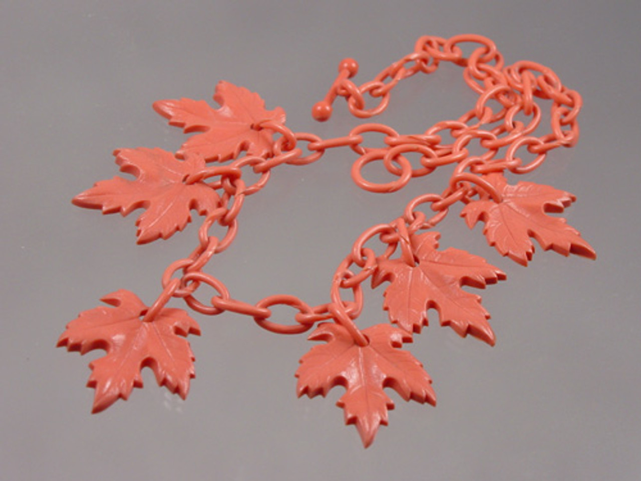 close up of maple leaves on necklace