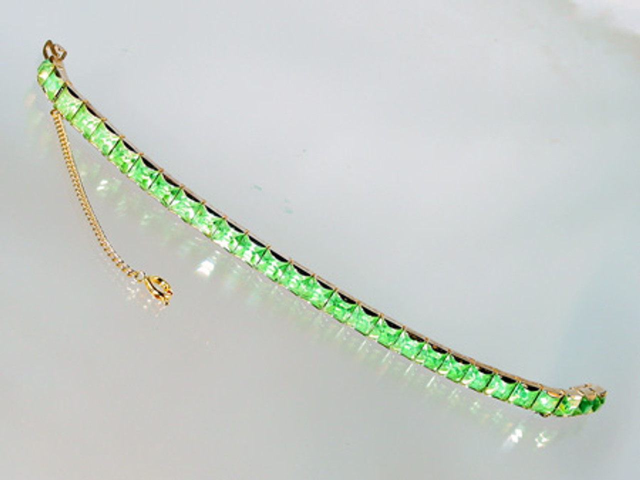 Tennis bracelet with square cut green crystals