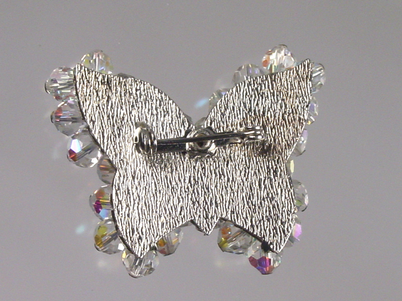 Textured silver backing on brooch