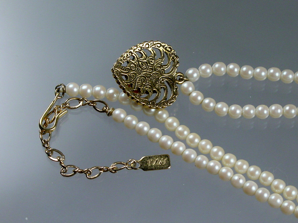 Signed 1928 on tag with 1928 swirls on back of heart