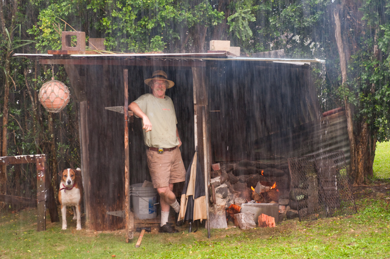 Dave by the fire smiling in the rain with Haka Dog