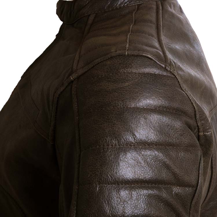 Detailed view of the shoulder and arm of a men's brown leather motorcycle jacket