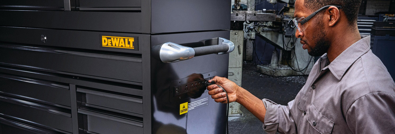 Mechanic plugging in powercord on Dewalt 9-Drawer Toolbox