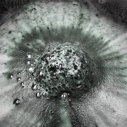 King Pin CBD bath bomb fizzing in bath water, creating a colorful swirl