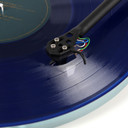 Top view close up view of a cartridge playing on a blue record