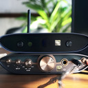 iFi ZEN Air Blue 2 connected to stereo amplifier via RCA cables showing desktop Bluetooth streaming setup