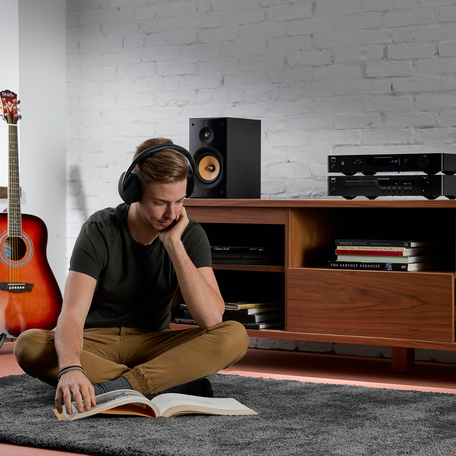 NAD C 338 Hybrid Digital Amplifier with man with headphones listening to music
