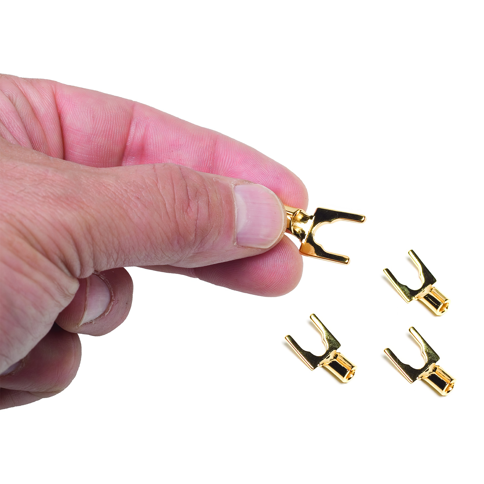 Hand holding a gold spade with more under it