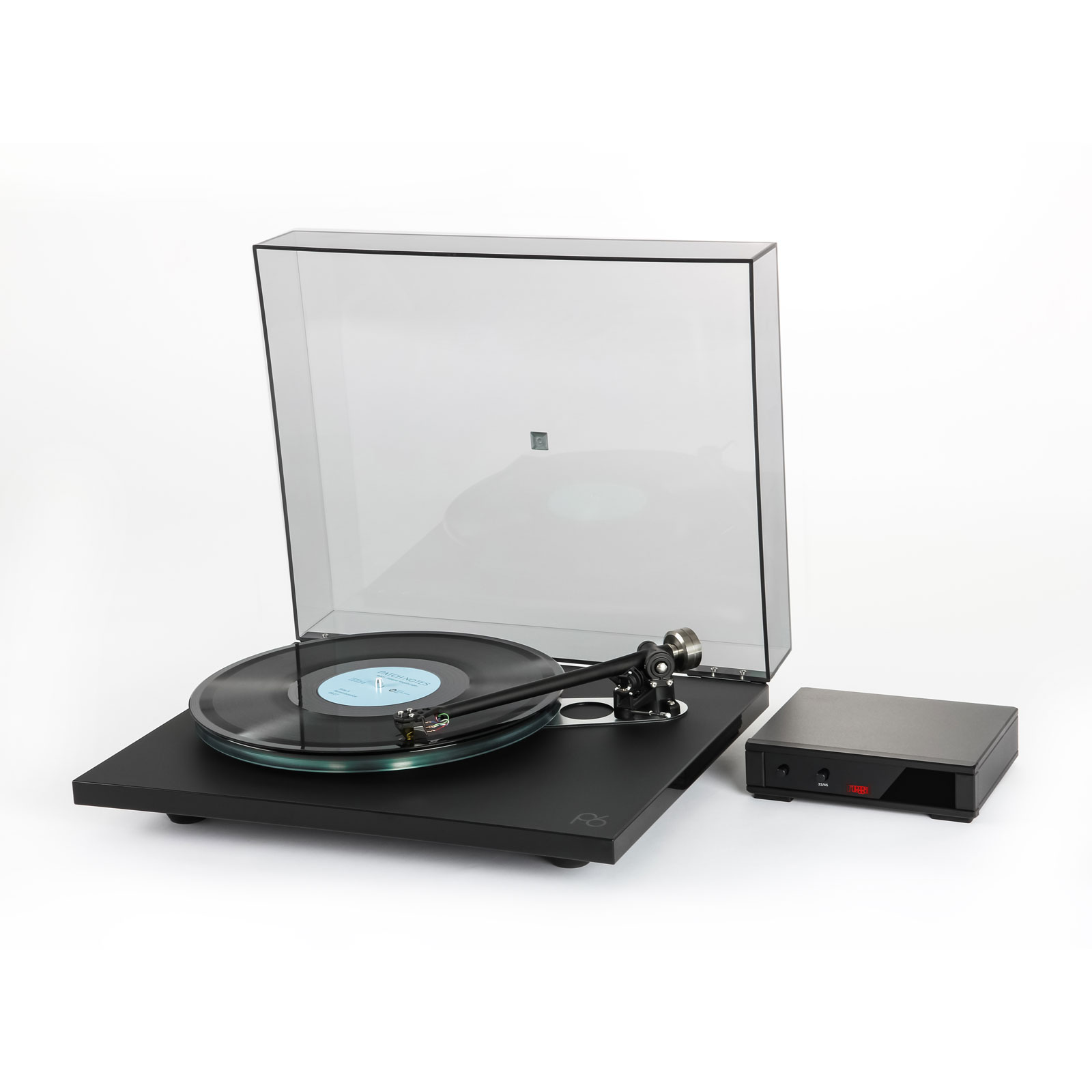 Left facing angle of the Rega Planar 6 Turntable in Polaris Gray with the Nd7 Cartridge, record and the Neo MK2 PSU