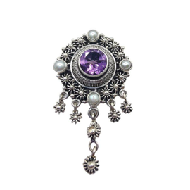 Round, faceted amethyst set in an intricate, oxidized setting with four mabe pearls set N,E,S,W with dangling stars. May also be worn as a brooch.