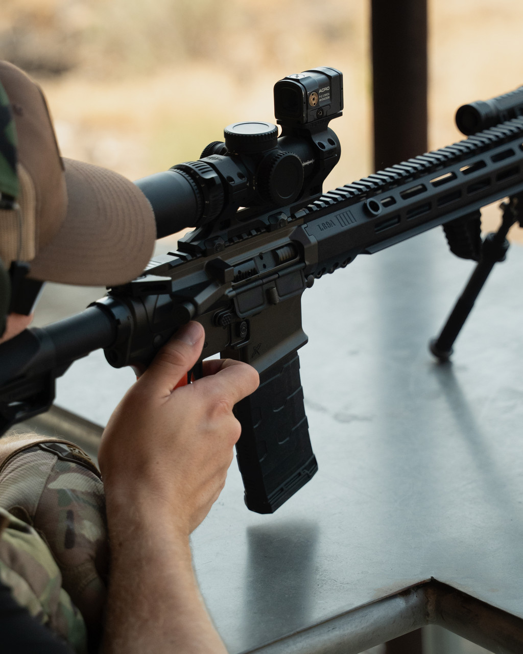Shooter loading a polymer AR-15 magazine at the range