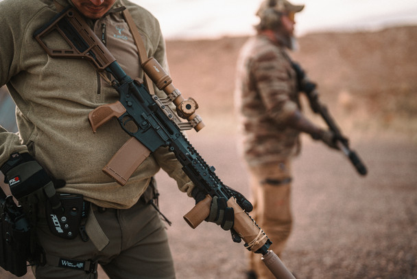 Two shooters in the field with AR-15 rifles fitted with polymer magazines