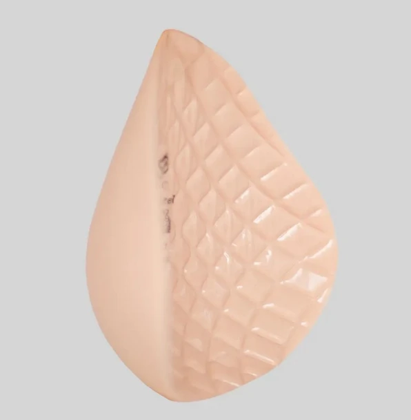 ABC 11287 Diamond Shaper lightweight silicone breast form in blush, featuring a textured cooling back and tapered edges for seamless post-surgery symmetry.