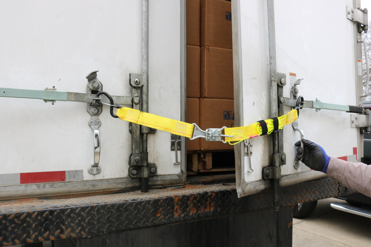 Releasable Trailer Door Limit Strap