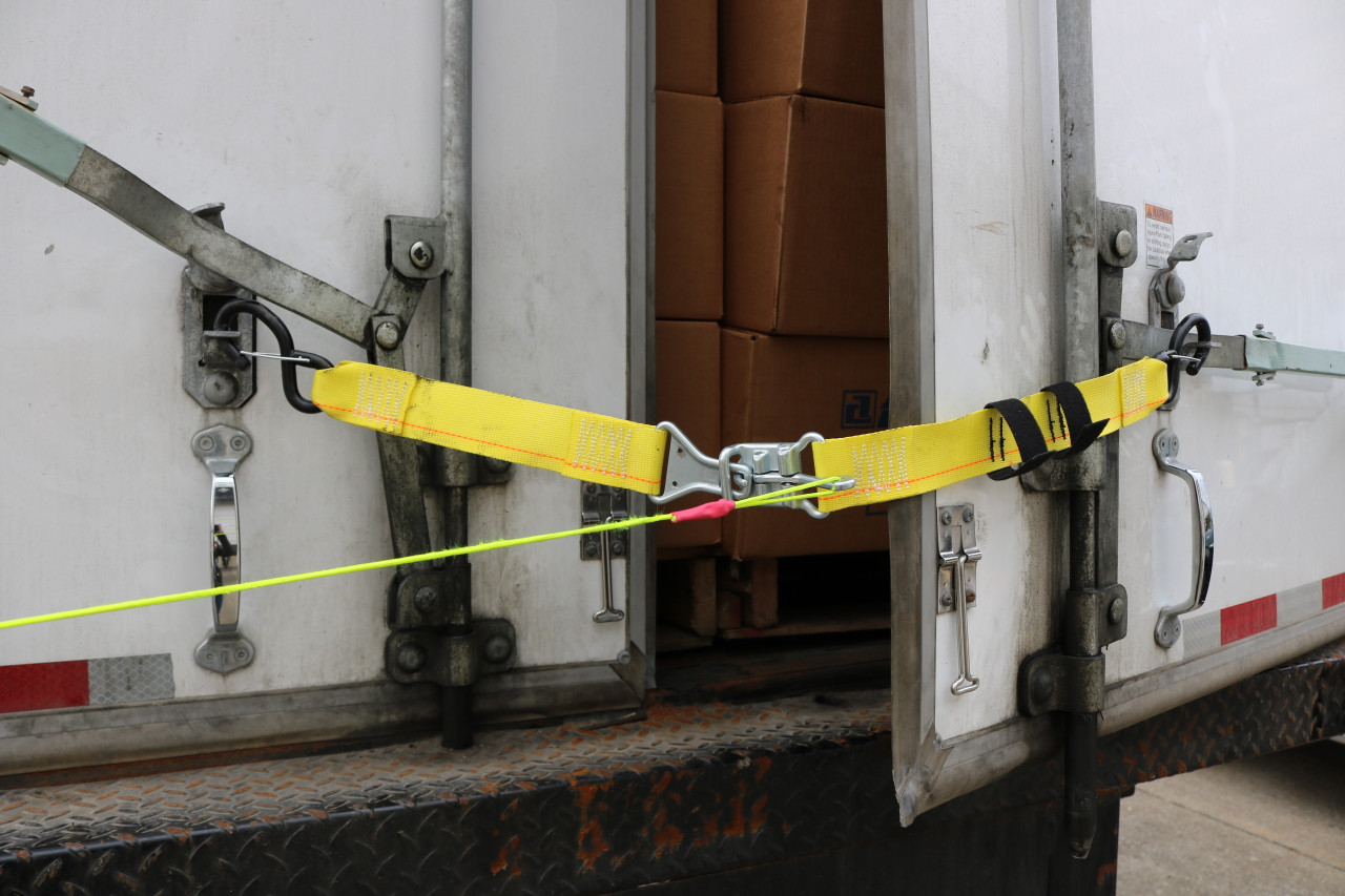 Releasable Trailer Door Limit Strap