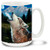 A howling wolf bays in the mountain twilight. Vivid, close-up view of a majestic wolf during a full moon. 15oz coffee mug