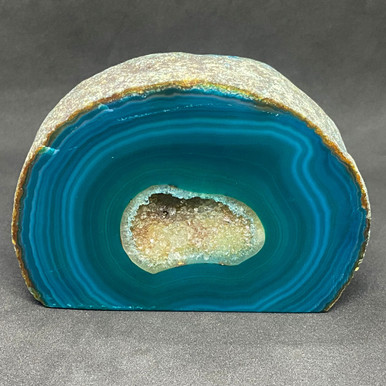 Agate base cut geode showing natural banding and a crystal lined centre