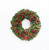  Elegant magnolia Christmas wreath with ruby-red pomegranates, red berries, and natural pinecones for festive front door and holiday home décor.