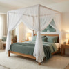 Silk box mosquito net draped as a canopy over a king bed