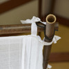 Single cotton box mosquito net tied onto the corner of a bamboo frame