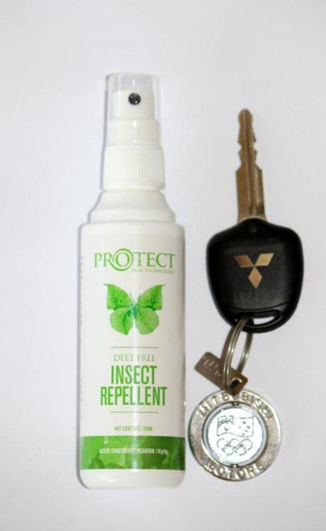 Protect insect repellent spray next to a set of keys to show its size