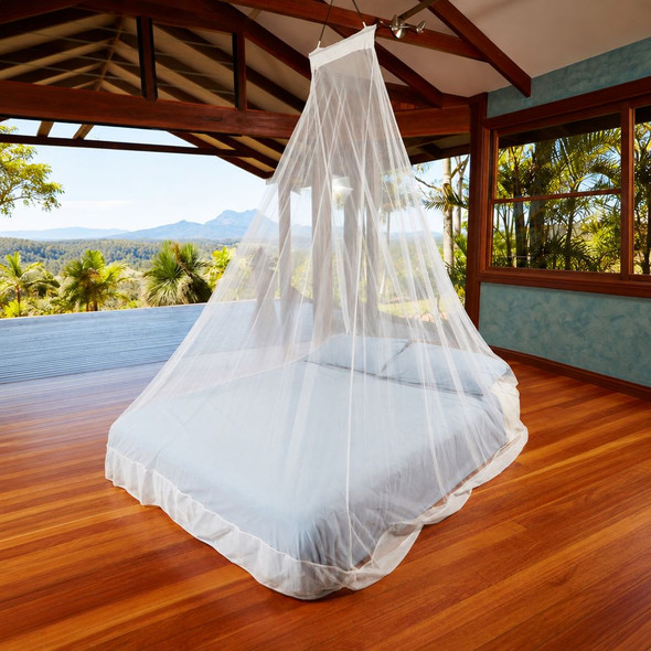 WedgeNet double travel mosquito net hanging from a single point over a bed