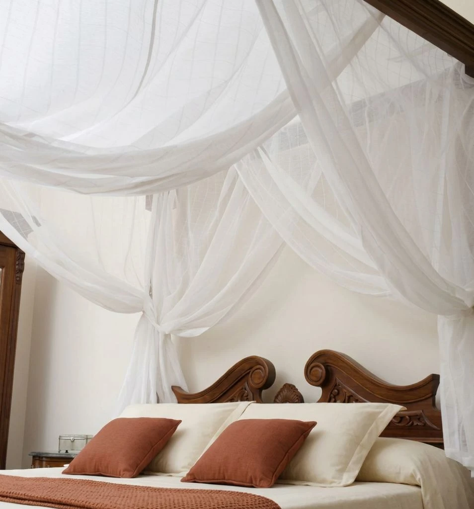 Mosquito net bed canopy on a four poster bed