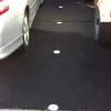 white car bay dot next to two cars