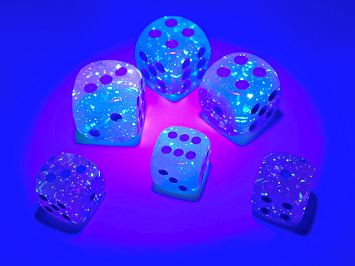under a light, dice sparkling