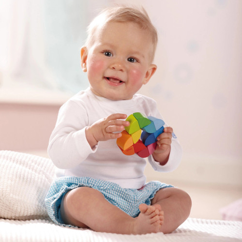Baby playing with Rainbow Ring Clutch Toy