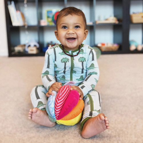 Infant playing with Rainbow Fabric Ball 