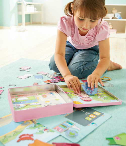 Child playing with Lilli Dress-up Doll Mag Tin 