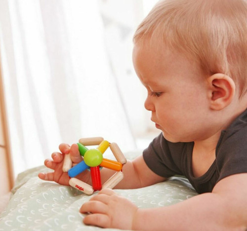 Child playing with Color Carousel Clutch Toy 