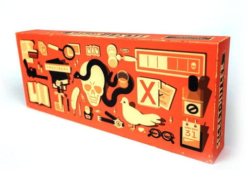 Secret Hitler front of orange box with various objects a skull with snake, watch, journal ect